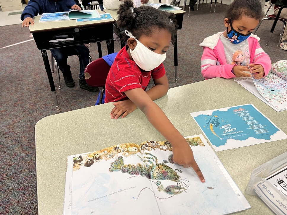 Student at Bond Elementary School reading Swimmy by Leo Lionni.
